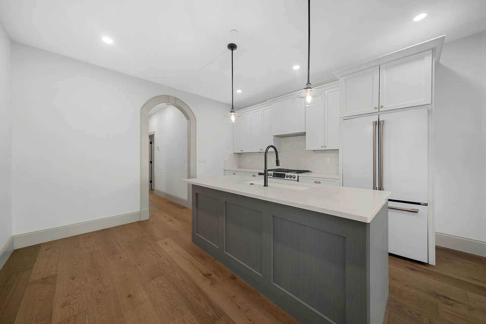 Finished kitchen with quartz island at 148 Lexington Street